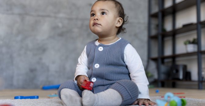 cute-baby-playing-floor-with-toy